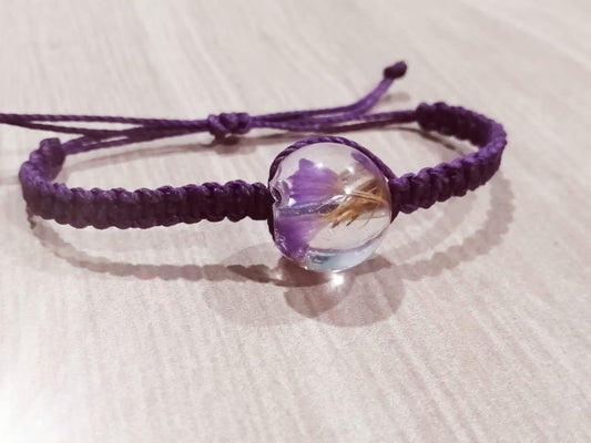 Pulsera tejida morada con flores secas