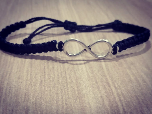 Pulsera tejida negra con simbolo de infinito